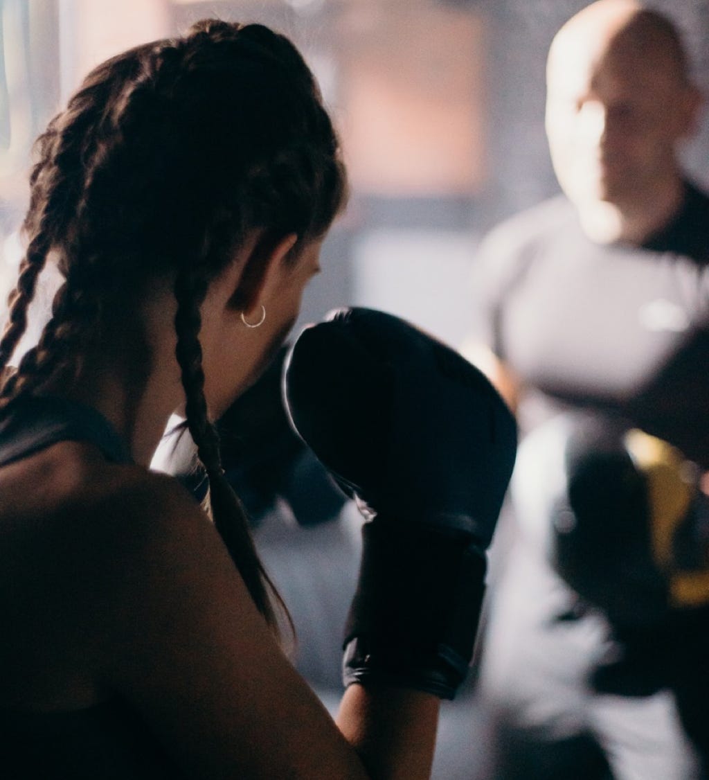 teenage girl with boxing gloves preparing to train